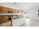 Eat-in kitchen with island, wood cabinets, granite counters and access to the patio at 315 Barletta Ave, Las Vegas, NV 89123