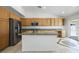 Eat-in kitchen with wood cabinets, stainless appliances, and access to the backyard at 315 Barletta Ave, Las Vegas, NV 89123