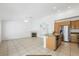Spacious living room and kitchen area featuring neutral tile floors and a fireplace in a well-lit interior at 315 Barletta Ave, Las Vegas, NV 89123