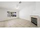Cozy living room with tile flooring, fireplace, and sliding glass doors to patio at 315 Barletta Ave, Las Vegas, NV 89123