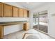 Hall office area with custom built-ins and sliding glass doors out to the pool and backyard at 315 Barletta Ave, Las Vegas, NV 89123