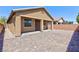 View of the backyard featuring a covered patio, brick privacy wall and desert landscaping at 7137 Flowering Rose Ave, Las Vegas, NV 89117