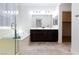 Luxurious bathroom featuring a soaking tub, dual sinks, and a separate glass-enclosed shower at 7137 Flowering Rose Ave, Las Vegas, NV 89117