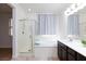 Bright bathroom featuring separate soaking tub and shower with dark wooden cabinets at 7137 Flowering Rose Ave, Las Vegas, NV 89117