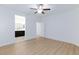 Open bedroom with a glimpse of the connected bathroom, and a modern ceiling fan at 7137 Flowering Rose Ave, Las Vegas, NV 89117