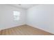 Bright bedroom with wood-look flooring and natural light streaming through the window at 7137 Flowering Rose Ave, Las Vegas, NV 89117