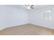 Light, airy bedroom with hardwood floors, a ceiling fan, and large windows for natural light at 7137 Flowering Rose Ave, Las Vegas, NV 89117