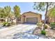 Inviting one-story home with a paved driveway, attached garage, and verdant landscaping surrounding the property at 7137 Flowering Rose Ave, Las Vegas, NV 89117