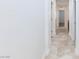 Well-lit hallway features neutral paint and tile flooring, creating a cohesive look at 7137 Flowering Rose Ave, Las Vegas, NV 89117