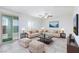 Virtually staged living room with stylish furnishings, sliding doors, and plenty of natural light at 7137 Flowering Rose Ave, Las Vegas, NV 89117