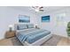 A cozy main bedroom with ocean-themed décor, a ceiling fan and large windows for natural light at 7137 Flowering Rose Ave, Las Vegas, NV 89117