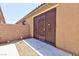 A gated side entrance of a home with a decorative metal gate and a small gravel area at 7137 Flowering Rose Ave, Las Vegas, NV 89117