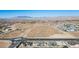 Aerial view of a neighborhood in a desert landscape with mountains in the background at 8863 Italian Trotter Ct, Las Vegas, NV 89113