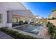 This backyard features a swimming pool, patio, and grassy area at 8863 Italian Trotter Ct, Las Vegas, NV 89113