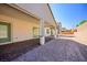 Spacious backyard with a covered patio, brick pavers, and desert landscaping at 8863 Italian Trotter Ct, Las Vegas, NV 89113