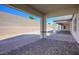 Spacious backyard with a covered patio, brick pavers, and desert landscaping at 8863 Italian Trotter Ct, Las Vegas, NV 89113