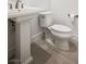 Bathroom featuring white pedestal sink and toilet at 8863 Italian Trotter Ct, Las Vegas, NV 89113