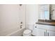 Bright bathroom featuring a tub-shower combo, white-patterned tile, and a modern vanity with a gray countertop at 8863 Italian Trotter Ct, Las Vegas, NV 89113