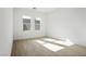 Bright bedroom with light wood-look floors and natural light streaming through the two windows at 8863 Italian Trotter Ct, Las Vegas, NV 89113