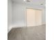 Spacious room featuring light-colored wood-look floors and large sliding glass doors with privacy shade at 8863 Italian Trotter Ct, Las Vegas, NV 89113