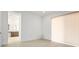 Empty room with light-colored wood-look flooring, leading to an attached bathroom and glass sliding doors at 8863 Italian Trotter Ct, Las Vegas, NV 89113