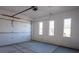 Bright two car garage with concrete floors, white walls, and windows at 8863 Italian Trotter Ct, Las Vegas, NV 89113