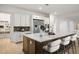 Modern kitchen with large island, stainless appliances, and decorative elements creating a stylish cooking space at 8863 Italian Trotter Ct, Las Vegas, NV 89113