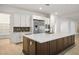 Well-lit kitchen with stainless steel appliances, white cabinets, and a large island perfect for meal prep at 8863 Italian Trotter Ct, Las Vegas, NV 89113