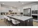 Kitchen with stainless appliances, spacious island with barstool seating enhancing the cooking and dining experience at 8863 Italian Trotter Ct, Las Vegas, NV 89113