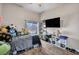 Bright bedroom with plush animals, a ceiling fan, and ample natural light from the window at 90 Ancient Hills Ln, Henderson, NV 89074