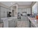 Kitchen with gray cabinets, stainless steel appliances and a center island with a marble countertop at 90 Ancient Hills Ln, Henderson, NV 89074