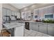 The kitchen showcases gray cabinets, stainless steel appliances, and marble countertops at 90 Ancient Hills Ln, Henderson, NV 89074