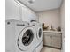 Well-equipped laundry room with modern washer and dryer and sink at 90 Ancient Hills Ln, Henderson, NV 89074