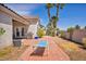 Back patio area with lounge chair, grill, and desert landscaping at 90 Ancient Hills Ln, Henderson, NV 89074