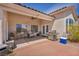 Relaxing covered patio with tiled flooring and comfortable seating arrangements, great for outdoor living at 90 Ancient Hills Ln, Henderson, NV 89074