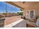 Cozy covered patio with outdoor furniture, ideal for relaxing or entertaining in the backyard at 90 Ancient Hills Ln, Henderson, NV 89074