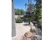 Backyard oasis featuring rock waterfall, tropical plants, and lush greenery at 9705 Floweret Ave, Las Vegas, NV 89117