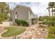 Two-story home with backyard featuring a waterfall and artificial turf at 9705 Floweret Ave, Las Vegas, NV 89117