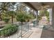 Covered patio features a ceiling fan and overlooks a garden area at 9705 Floweret Ave, Las Vegas, NV 89117