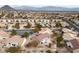 An aerial view of neighborhood with desert landscaping, tile roofs, and mountain views in the distance at 9917 Arbuckle Dr, Las Vegas, NV 89134