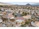 An aerial view of neighborhood featuring desert landscaping and majestic mountains in the background at 9917 Arbuckle Dr, Las Vegas, NV 89134