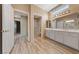 Bathroom with double vanity, a large mirror, and a glass-enclosed shower at 9917 Arbuckle Dr, Las Vegas, NV 89134