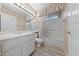 Bright bathroom features a large vanity, toilet, and shower-tub combination with floral curtain at 9917 Arbuckle Dr, Las Vegas, NV 89134