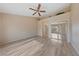 Neutral bedroom featuring a ceiling fan, mirrored closet doors and plank flooring at 9917 Arbuckle Dr, Las Vegas, NV 89134
