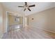 Spacious bedroom showcasing plank flooring, a ceiling fan, and a mirrored closet at 9917 Arbuckle Dr, Las Vegas, NV 89134