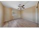 Cozy bedroom featuring a ceiling fan and plank flooring, bright natural light, and neutral walls at 9917 Arbuckle Dr, Las Vegas, NV 89134