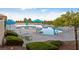Resort-style community pool area features comfortable lounge chairs, umbrellas, and lush landscaping at 9917 Arbuckle Dr, Las Vegas, NV 89134