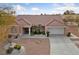 Charming single-story home features a well-manicured yard, beautiful desert landscaping, and a tile roof at 9917 Arbuckle Dr, Las Vegas, NV 89134