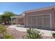 Exterior view of the home showcasing the screened in patio and desert landscaping at 9917 Arbuckle Dr, Las Vegas, NV 89134