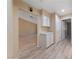 Hallway with view of built-in storage, plank flooring, and a view into another room at 9917 Arbuckle Dr, Las Vegas, NV 89134